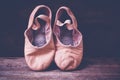 Ballet shoes on wooden floor. Royalty Free Stock Photo