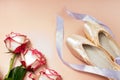 ballet slippers lying on pink background with roses and ribbons. elegant ballet shoes bouquet. beauty dance Royalty Free Stock Photo