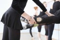 Ballet Teacher Adjusting Foot Positions Of Ballerinas