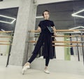 ballet teacher in the choreography class stands at the ballet machine showing the eversion of the foot Royalty Free Stock Photo