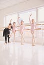 Ballet teacher correcting foot position of young student Royalty Free Stock Photo
