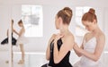 Ballet woman with help from girl with clothes before training, exercise or abstract dance routine. Ballerina student in