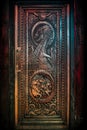 BALLINTOY HARBOUR, NORTHERN IRELAND, DECEMBER 20, 2018: Magnificent carved door with dragons and Dothraki horses, made with wood Royalty Free Stock Photo