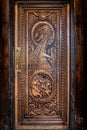 BALLINTOY HARBOUR, NORTHERN IRELAND, DECEMBER 20, 2018: Magnificent carved door with dragons and Dothraki horses, made with wood