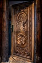 BALLINTOY HARBOUR, NORTHERN IRELAND, DECEMBER 20, 2018: Magnificent carved door with dragons and Dothraki horses, made with wood Royalty Free Stock Photo
