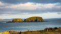 Ballintoy, Republic of Ireland, UK - 28 December, 2016 : A couple of tourist photographing the sheep island near giant causeway