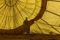 Human shadow seeing inside of a yellow ballon