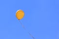 Yellow balloon flying in blue sky Royalty Free Stock Photo