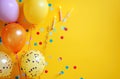 balloon decorations border with candles on bright yellow background Royalty Free Stock Photo