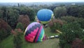 Balloon Festival. Inflating big balloon. Several balloons lie on ground, inflate