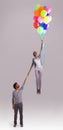 Balloon, flying and couple in studio for growth, celebration and present on gray background. independant, opportunity Royalty Free Stock Photo