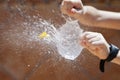 balloon full of exploding water, held by a child& x27;s hands with a needle