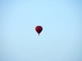 a balloon hanging in the sky. Red-stripped color