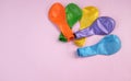Colorful Balloons are also not blown isolate on a pink pastel background.
