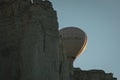 The balloon hides behind a rock at dawn