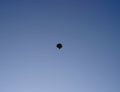 Balloon hot-air flies in the blue sky, far Royalty Free Stock Photo