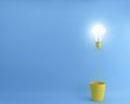 Balloon light bulbs with glowing in Yellow flower pot on blue background. Royalty Free Stock Photo