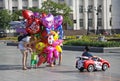 Balloon Seller and a buyer with children on the Lenin square in Khabarovsk