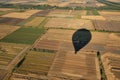 balloon shadow on patchwork farmland from above