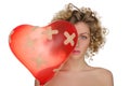 Balloon in shape of heart and hurt woman