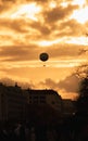 A balloon in the sunset sky in the city