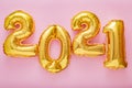 2021 balloon text on pink background. Happy New year eve invitation with Christmas gold foil balloons 2021. Flat lay long web Royalty Free Stock Photo