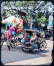 balloon traders and pedicab drivers who are waiting for customers