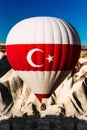 Balloon with Turkish flag. Balloons in the sky over Turkey at sunrise. Colorful hot air balloon moving up in blue sky. A lonely