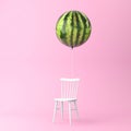 Balloon watermelon with chair concept on pastel pink background.