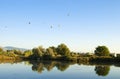 Balloons Above a Quiet Pond Royalty Free Stock Photo