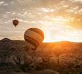 Balloons against the background of rocks at dawn. Huge multicolored balls in the sunlight of dawn. Turkey. Cappadocia. Goreme Nati