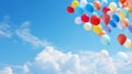 Balloons of all sizes soaring against a blue sky, forming a backdrop for an open-air birthday party