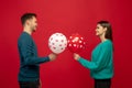 Beautiful couple in love on red studio background. Valentine's Day, love and emotions concept Royalty Free Stock Photo