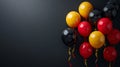 Balloons black, yellow, red on a black background. Balloons in the colors of the national flag of Germany. Celebrating Royalty Free Stock Photo