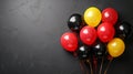 Balloons black, yellow, red on a black background. Balloons in the colors of the national flag of Germany. Celebrating Royalty Free Stock Photo