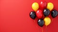 Balloons black yellow, red on a red background. Balloons in the colors of the national flag of Germany. Celebrating Royalty Free Stock Photo