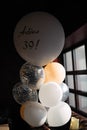Balloons in dark room, balloon inscription, adios thirty nine
