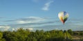 Balloons fly over the green fields, nature hills in summer Royalty Free Stock Photo