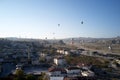 Balloons flying over small town of Goreme at Cappadocia. Royalty Free Stock Photo