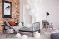 Balloons in industrial stylish bedroom, real photo with copy space Royalty Free Stock Photo