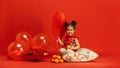 Happy Chinese New Year. Asian little girl portrait isolated on red background