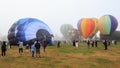 Group of hot air balloons at ballooning festival, shrouded in mist Royalty Free Stock Photo