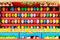 Balloons and prizes at a dart throwing game booth at a carnival, fair, or amusement park