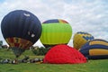 Balloons of red, blue, yellow, light green and orange inflate Royalty Free Stock Photo