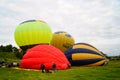 Balloons of red, blue, yellow, light green and orange inflate Royalty Free Stock Photo