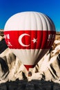 Balloons in the sky over Cappadocia at sunrise. Colorful hot air balloon moving up in blue sky. A lonely balloon in the sky above