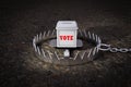 Ballot box is on a metal bear trap demonstrating Election risk. 3D illustration. Royalty Free Stock Photo