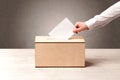 Ballot box with person casting vote Royalty Free Stock Photo