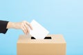 Ballot box with person casting vote on blank voting slip Royalty Free Stock Photo