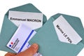 Ballot papers for Emmanuel Macron and Marine Le Pen with a close-up electoral card